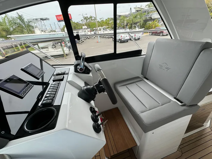  Yacht Photos Pics 2024 Sealine S335V boat cockpit with modern controls and seating.