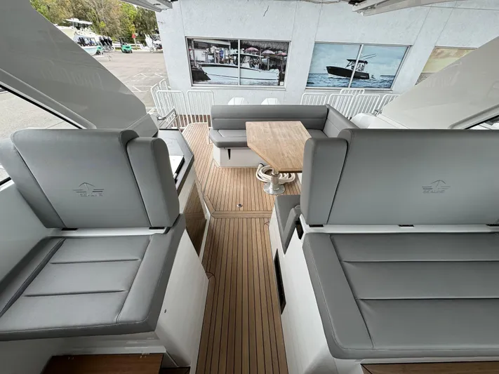  Yacht Photos Pics 2024 Sealine S335V yacht interior with gray seating and wooden flooring.