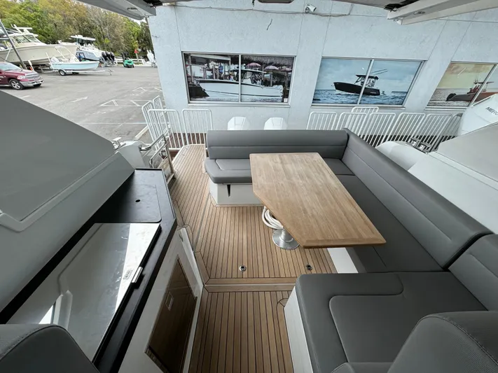  Yacht Photos Pics 2024 Sealine S335V yacht interior with sleek seating and wooden table on deck.