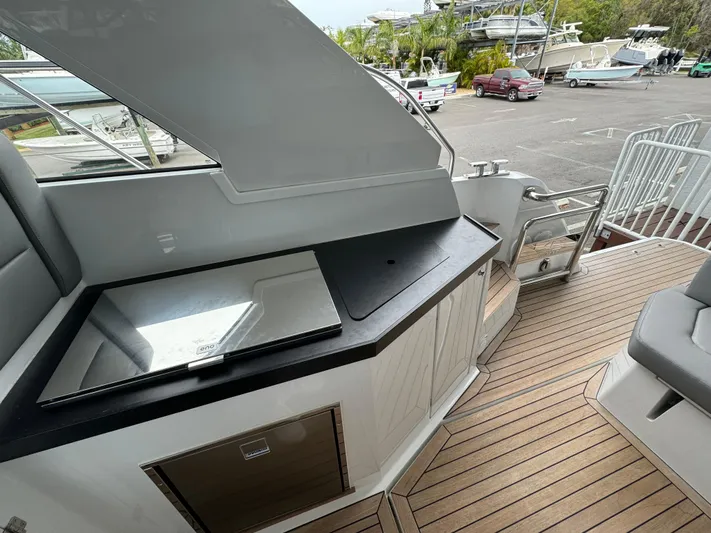  Yacht Photos Pics 2024 Sealine S335V yacht deck with sleek outdoor kitchen and seating area.