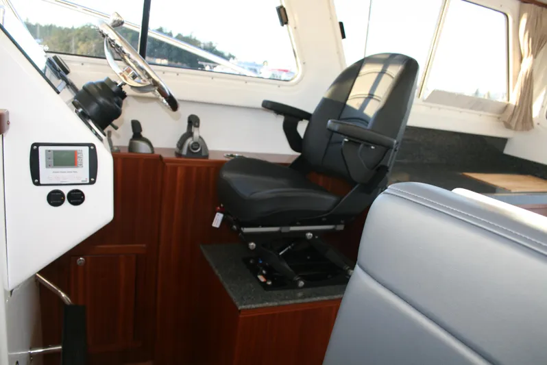  Yacht Photos Pics Interior of 2025 Ocean Sport Roamer 33' boat with captain's chair and controls.