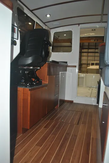  Yacht Photos Pics Interior of 2025 Ocean Sport Roamer 33' with wood flooring and modern seating.