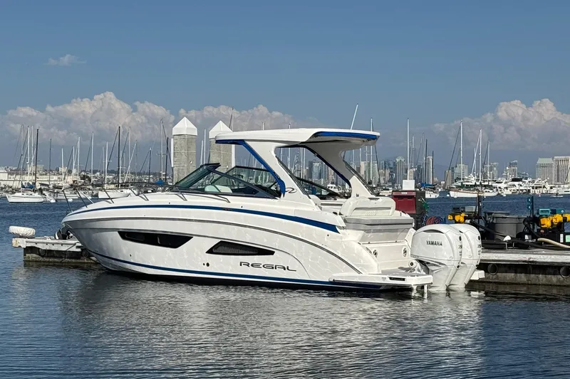 33 Xo Best Deals Of The Year!!1 Yacht Photos Pics 2026 Regal 33 XO boat docked in marina with city skyline background.