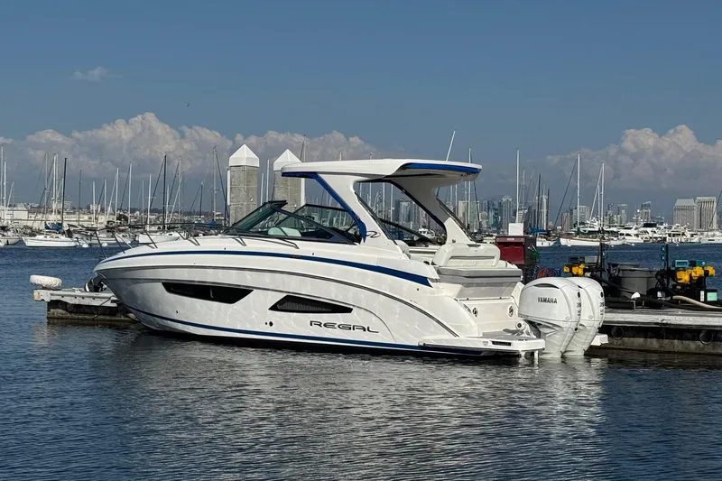 33 Xo Best Deals Of The Year!!1 Yacht Photos Pics 2026 Regal 33 XO boat docked in marina with city skyline background.