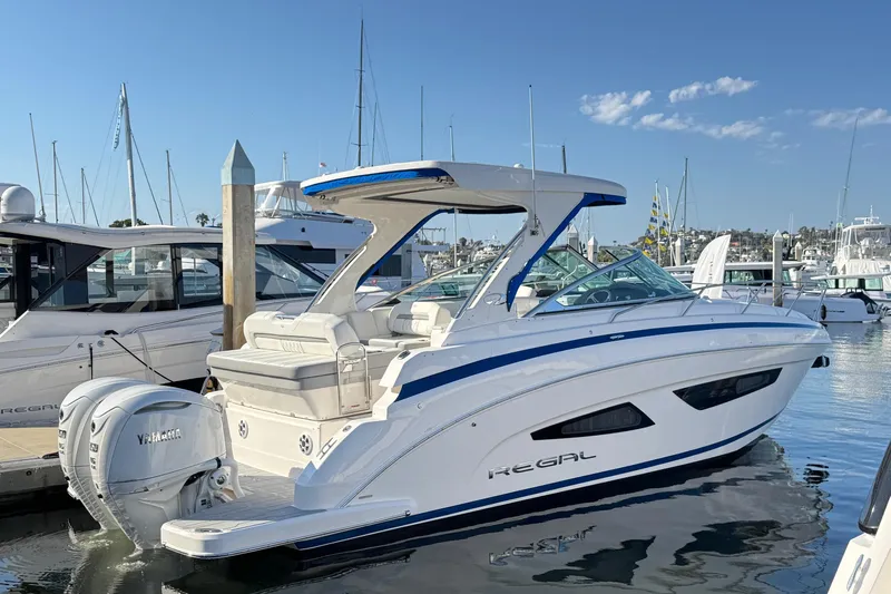 33 Xo Best Deals Of The Year!!1 Yacht Photos Pics 2026 Regal 33 XO boat docked in marina, featuring sleek design and Yamaha outboard engine.