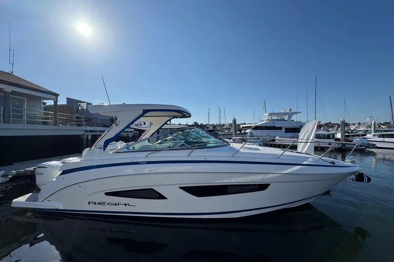 33 Xo Best Deals Of The Year!!1 Yacht Photos Pics 2026 Regal 33 XO boat docked at marina under clear blue sky.