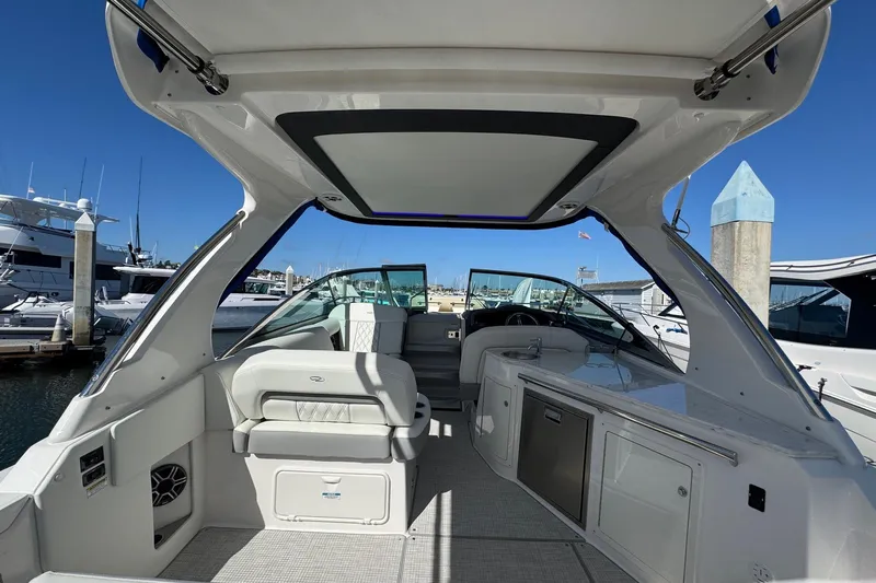 33 Xo Best Deals Of The Year!!1 Yacht Photos Pics 2026 Regal 33 XO boat interior with seating and kitchenette, docked at marina.