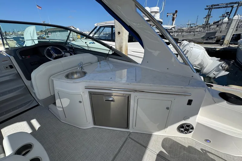 33 Xo Best Deals Of The Year!!1 Yacht Photos Pics 2026 Regal 33 XO boat interior with sink, counter, and steering wheel at marina.