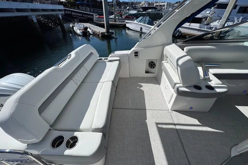 33 Xo Best Deals Of The Year!!1 Yacht Photos Pics 2026 Regal 33 XO yacht interior with luxurious seating and cup holders at a marina.