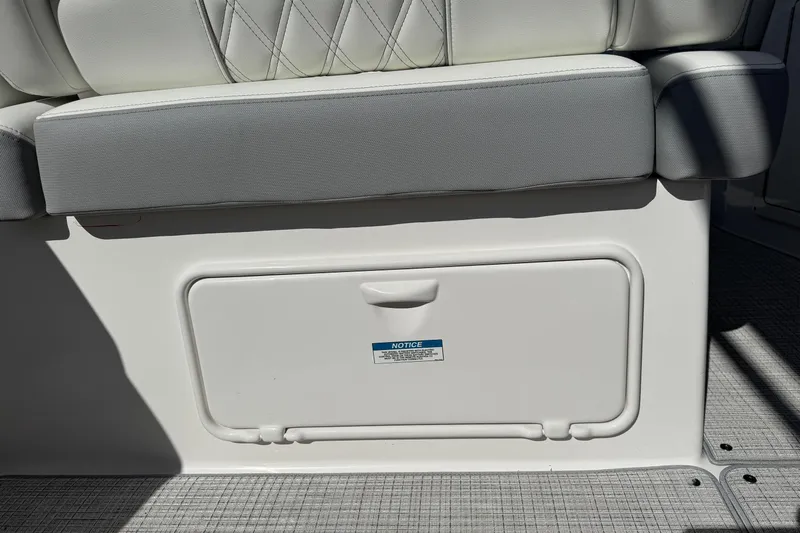 33 Xo Best Deals Of The Year!!1 Yacht Photos Pics 2026 Regal 33 XO boat seat with storage compartment, featuring white and gray upholstery.
