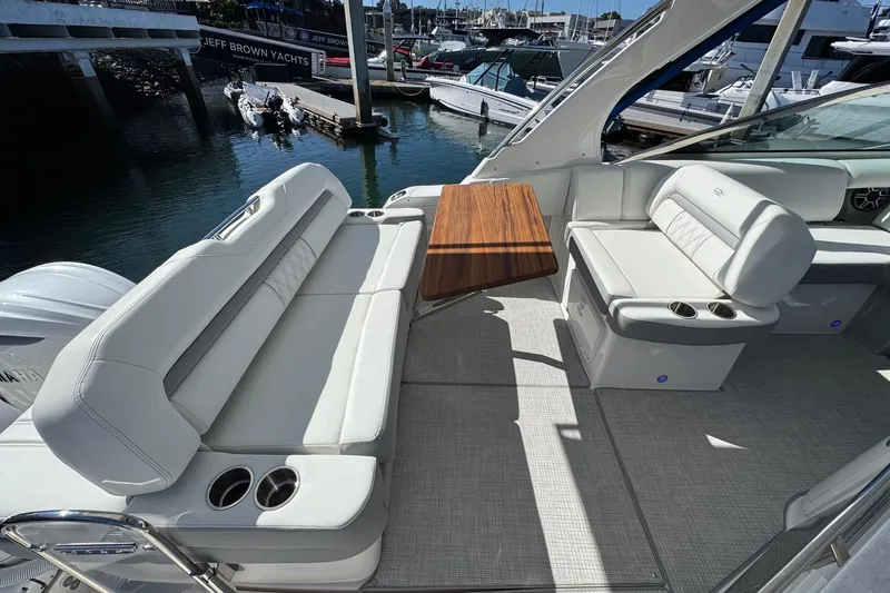 33 Xo Best Deals Of The Year!!1 Yacht Photos Pics 2026 Regal 33 XO yacht interior with white seating and wooden table.