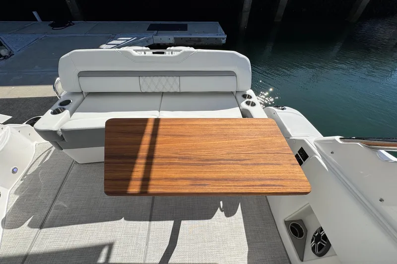 33 Xo Best Deals Of The Year!!1 Yacht Photos Pics 2026 Regal 33 XO boat interior with wooden table and cushioned seating.