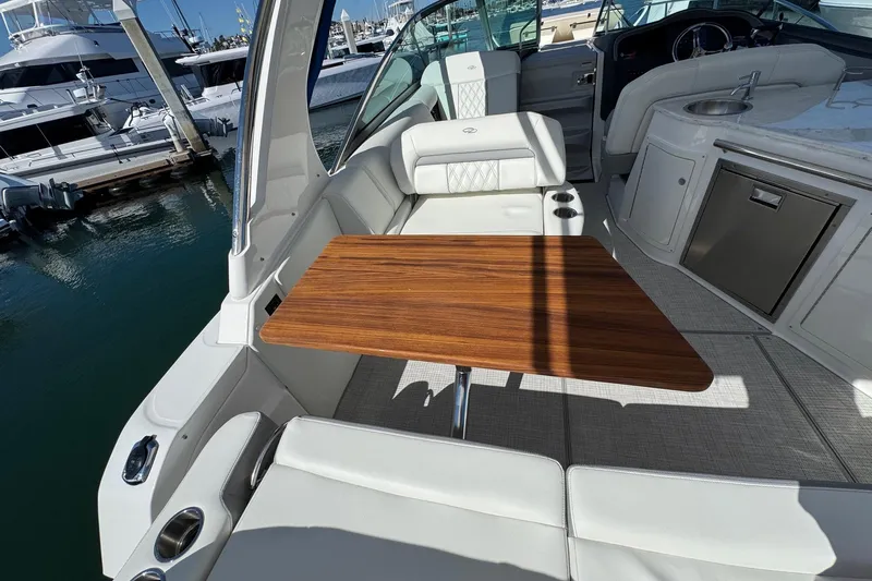 33 Xo Best Deals Of The Year!!1 Yacht Photos Pics Luxurious 2026 Regal 33 XO yacht interior with elegant seating and wooden table.