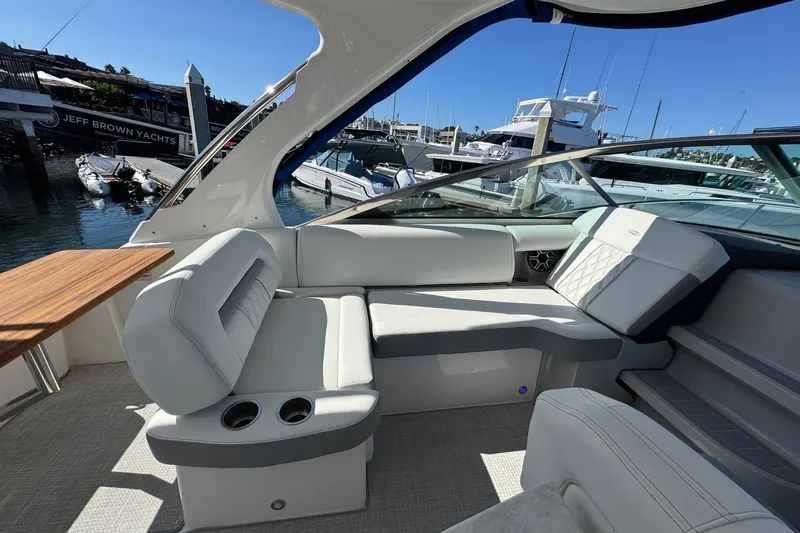 33 Xo Best Deals Of The Year!!1 Yacht Photos Pics Luxurious interior of 2026 Regal 33 XO yacht with elegant seating and wooden table.