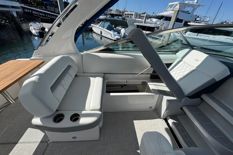 33 Xo Best Deals Of The Year!!1 Yacht Photos Pics 2026 Regal 33 XO yacht interior with luxurious seating and cup holders, docked at marina.
