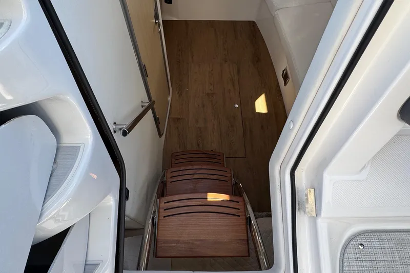 33 Xo Best Deals Of The Year!!1 Yacht Photos Pics Interior view of 2026 Regal 33 XO yacht with wooden steps and sleek design.