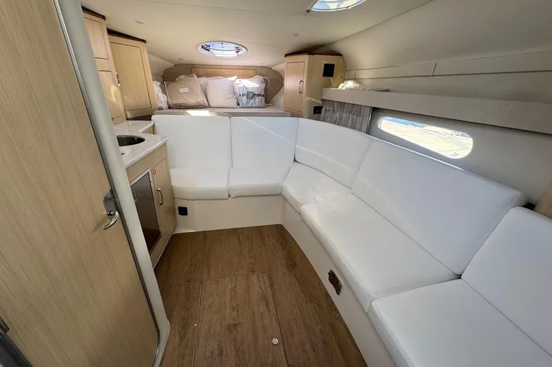 33 Xo Best Deals Of The Year!!1 Yacht Photos Pics Luxurious interior of 2026 Regal 33 XO yacht with white seating and wood accents.