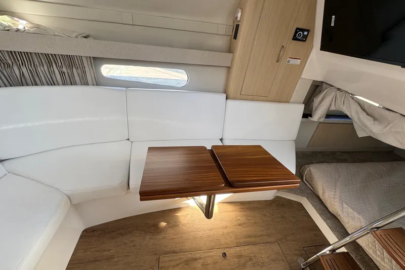 33 Xo Best Deals Of The Year!!1 Yacht Photos Pics 2026 Regal 33 XO interior with white seating, wooden table, and modern design.
