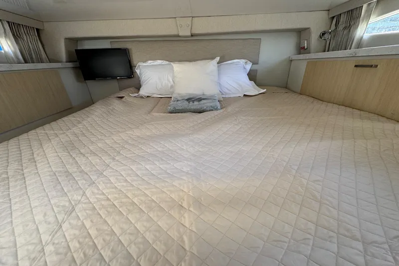 33 Xo Best Deals Of The Year!!1 Yacht Photos Pics Luxurious cabin interior of 2026 Regal 33 XO yacht with cozy bedding and TV.