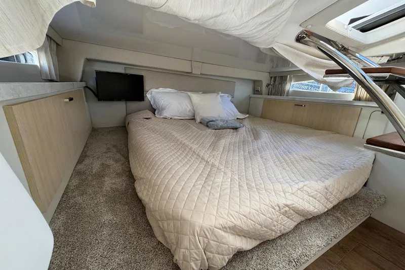 33 Xo Best Deals Of The Year!!1 Yacht Photos Pics Cozy cabin interior of 2026 Regal 33 XO yacht with bed and TV.