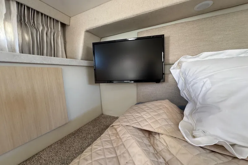 33 Xo Best Deals Of The Year!!1 Yacht Photos Pics Interior of 2026 Regal 33 XO yacht cabin with TV, bed, and curtains.
