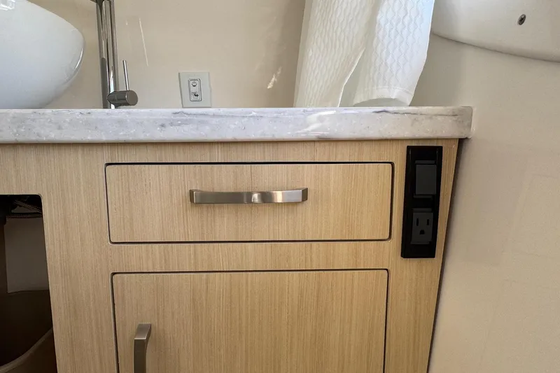 33 Xo Best Deals Of The Year!!1 Yacht Photos Pics 2026 Regal 33 XO yacht bathroom with wooden cabinet and marble countertop.