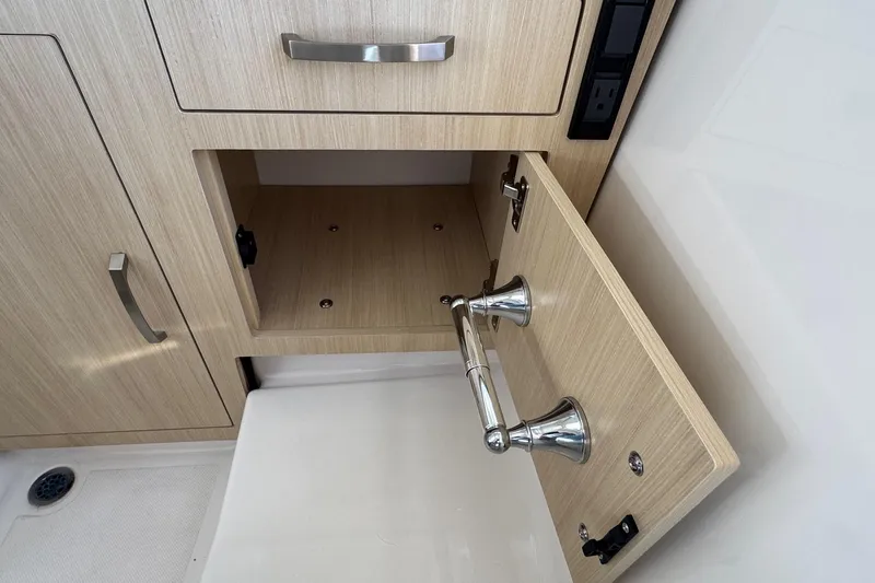 33 Xo Best Deals Of The Year!!1 Yacht Photos Pics 2026 Regal 33 XO boat interior cabinet with open storage and sleek metal handles.