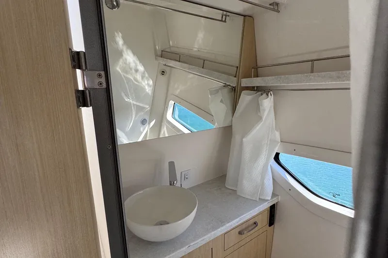 33 Xo Best Deals Of The Year!!1 Yacht Photos Pics 2026 Regal 33 XO yacht bathroom with modern sink, mirror, and window view.