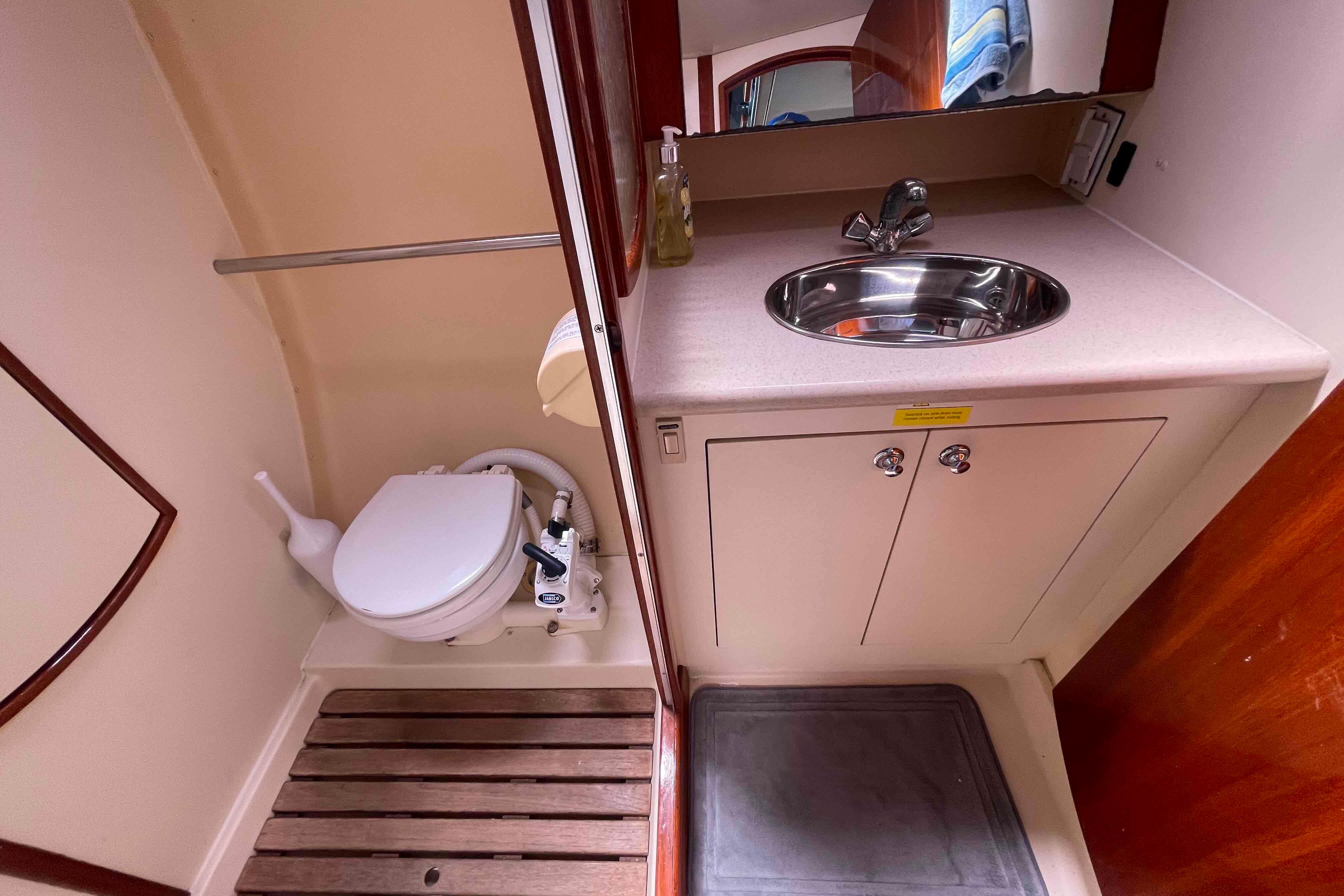 Compact bathroom in 2006 Hunter 36 yacht with sink and toilet.