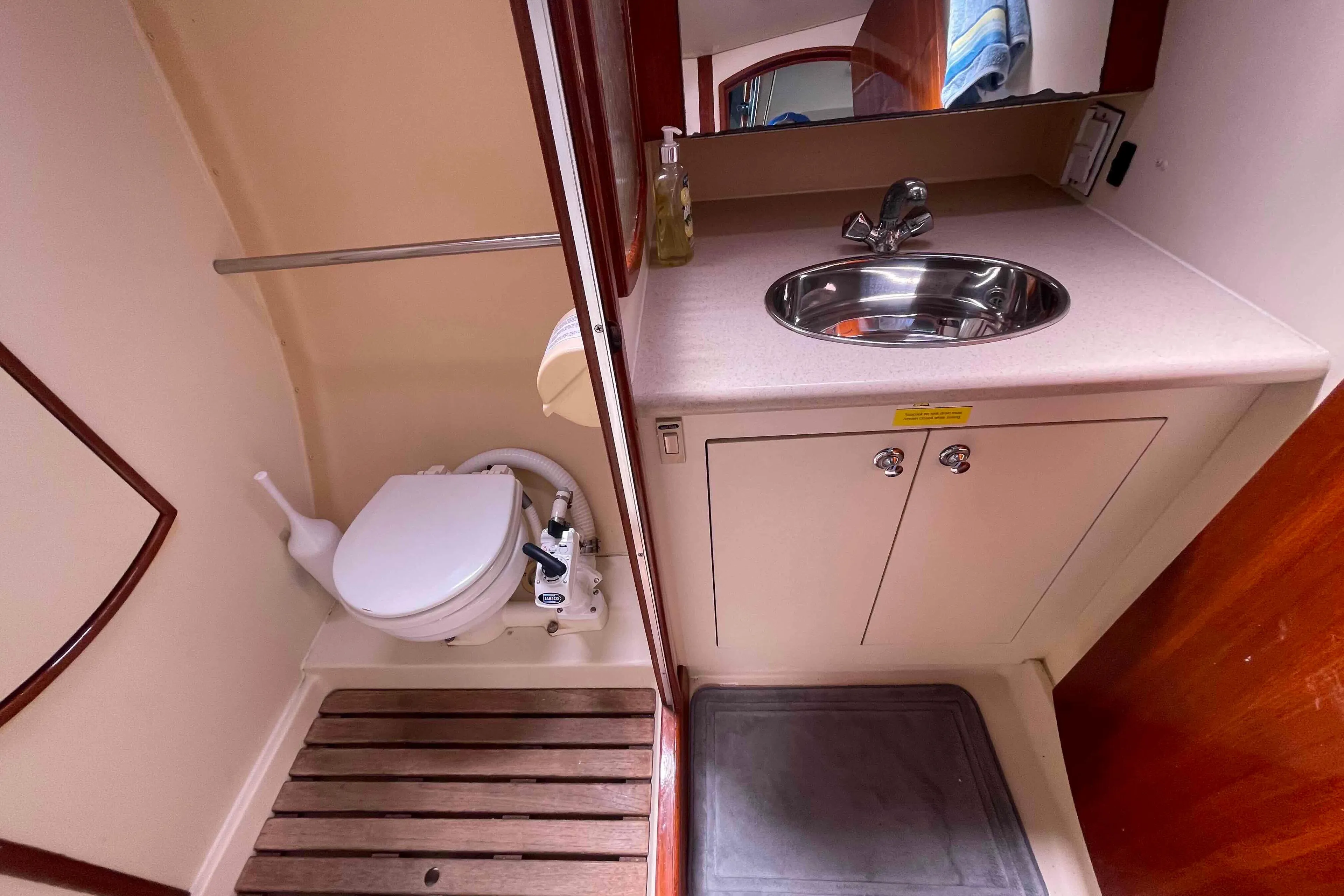 Compact bathroom in 2006 Hunter 36 yacht with sink and toilet.