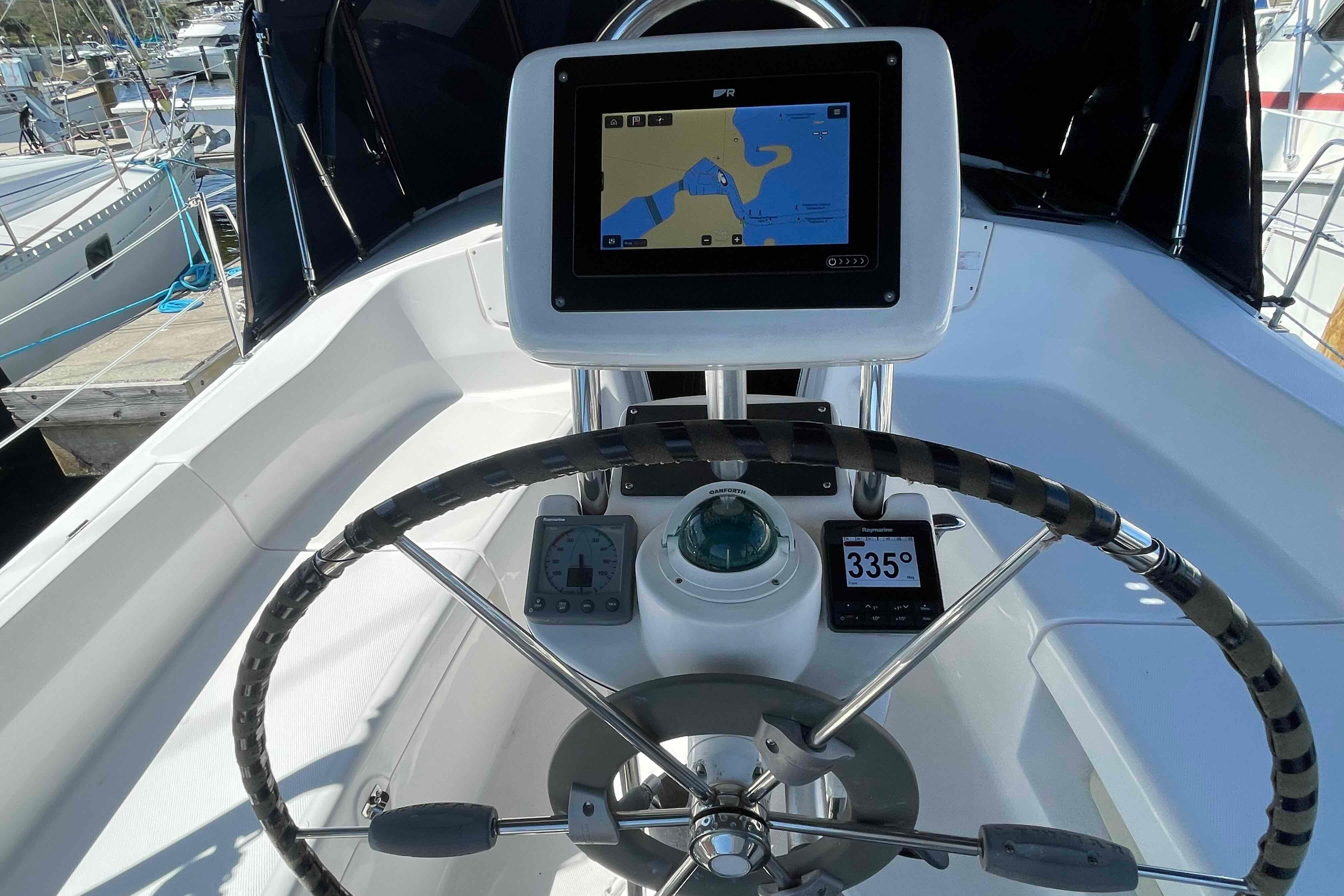 Steering wheel and navigation system on a 2006 Hunter 36 sailboat.