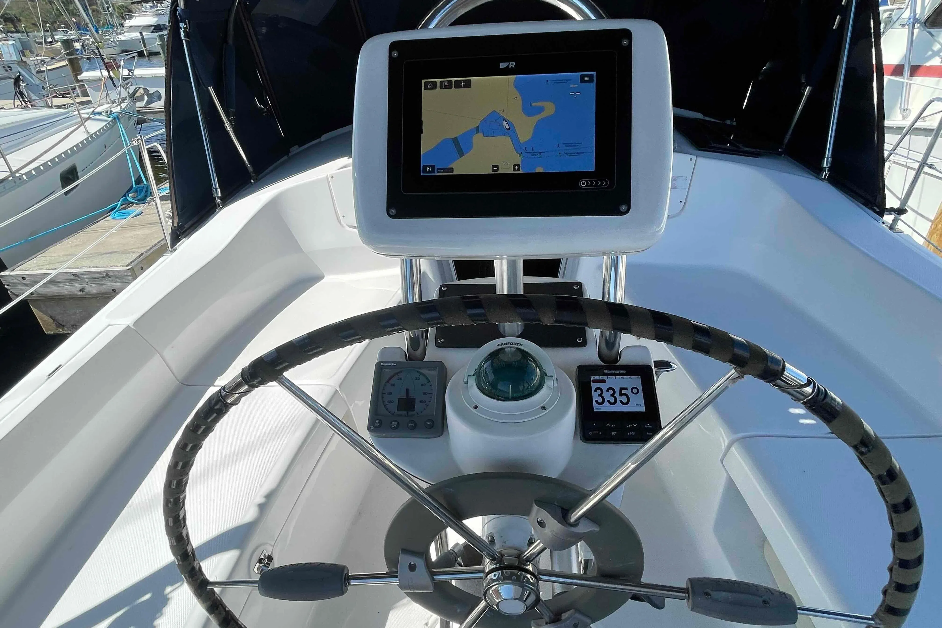 Steering wheel and navigation system on a 2006 Hunter 36 sailboat.