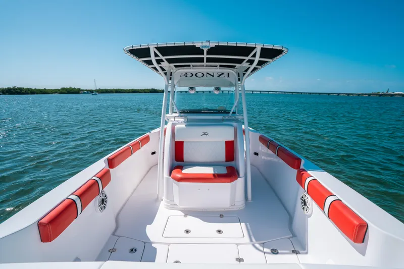  Yacht Photos Pics 2007 Donzi 38 ZF Cuddy boat with red seating, cruising on clear blue waters.