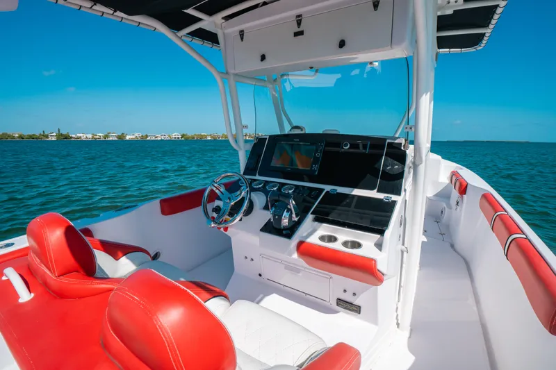  Yacht Photos Pics 2007 Donzi 38 ZF Cuddy boat interior with red and white seating, ocean view.