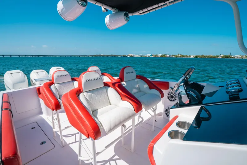  Yacht Photos Pics 2007 Donzi 38 ZF Cuddy boat with red and white seating on a sunny day.