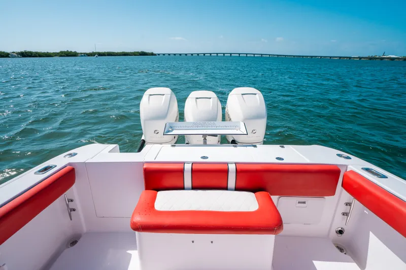  Yacht Photos Pics 2007 Donzi 38 ZF Cuddy boat with red seating, triple engines, on open water.