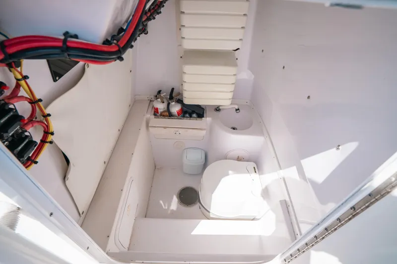  Yacht Photos Pics 2007 Donzi 38 ZF Cuddy interior with compact marine toilet and storage.