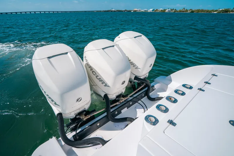  Yacht Photos Pics 2007 Donzi 38 ZF Cuddy with triple Mercury outboard engines on open water.