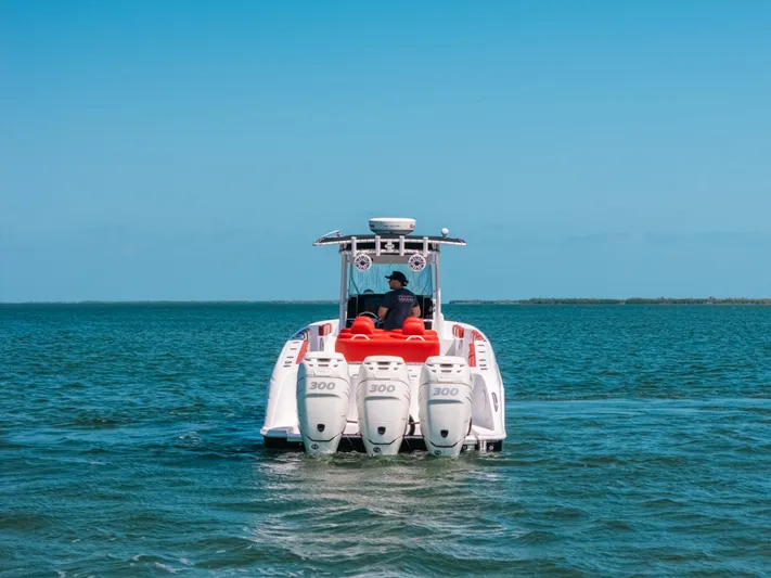  Yacht Photos Pics 2007 Donzi 38 ZF Cuddy boat with triple engines cruising on open water.