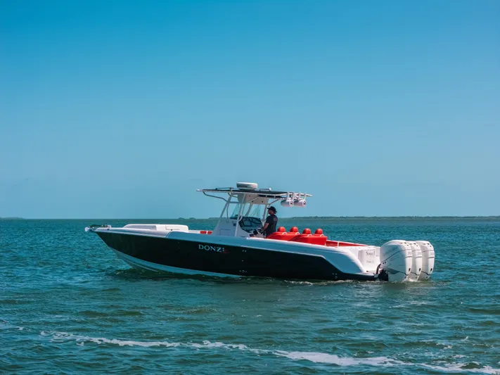  Yacht Photos Pics 2007 Donzi 38 ZF Cuddy boat cruising on open water under clear blue sky.