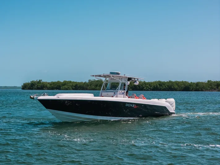  Yacht Photos Pics 2007 Donzi 38 ZF Cuddy boat cruising on a sunny day.