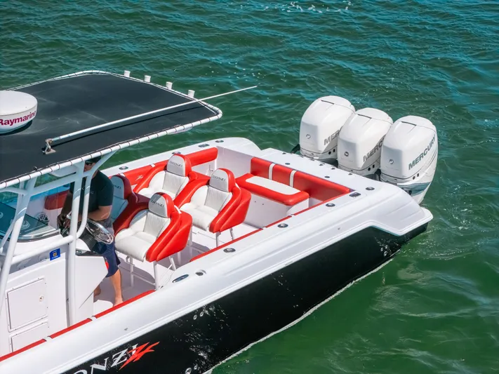  Yacht Photos Pics 2007 Donzi 38 ZF Cuddy boat with red seating and triple Mercury engines on water.