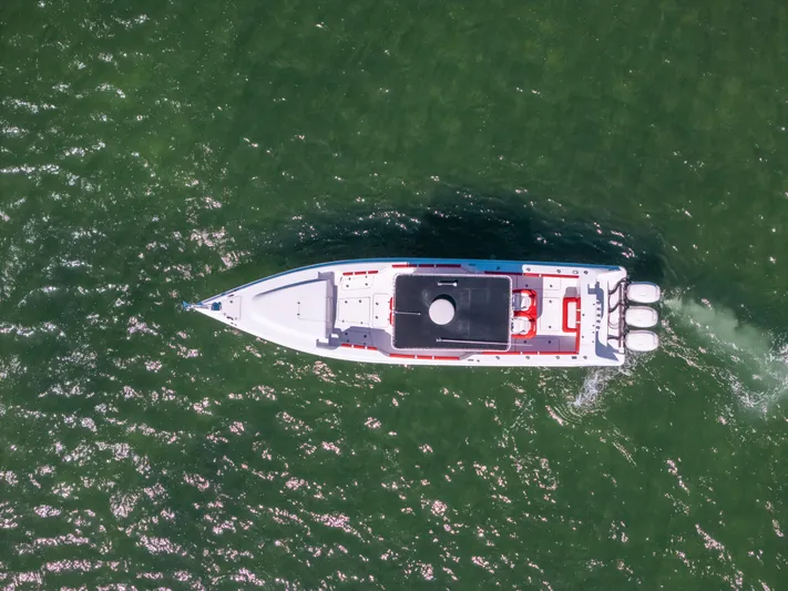  Yacht Photos Pics Aerial view of 2007 Donzi 38 ZF Cuddy boat cruising on green water.