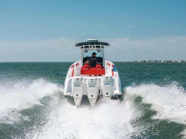  Yacht Photos Pics 2007 Donzi 38 ZF Cuddy speeding on open water, rear view.