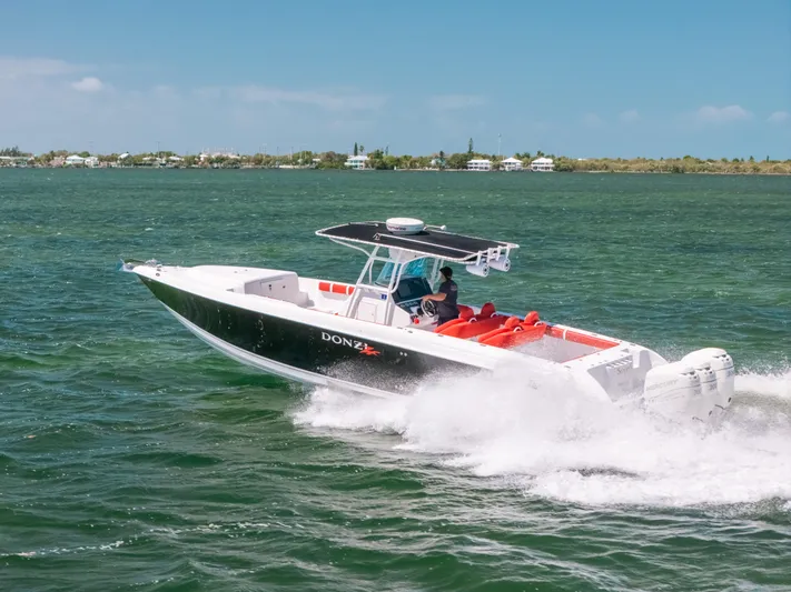  Yacht Photos Pics 2007 Donzi 38 ZF Cuddy speeding on open water under clear skies.