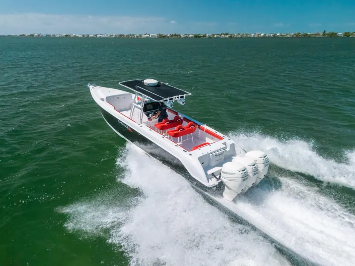  Yacht Photos Pics 2007 Donzi 38 ZF Cuddy boat speeding on open water, showcasing powerful engines.