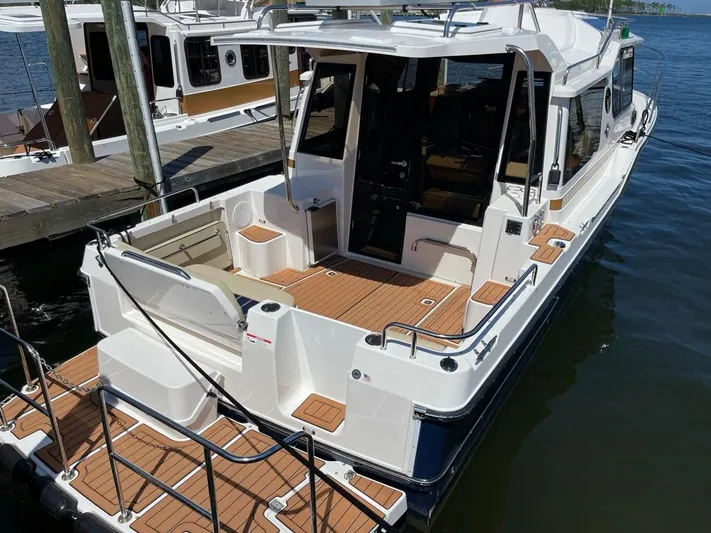  Yacht Photos Pics 2025 Ranger Tugs R-29 S boat docked, featuring spacious deck and modern design.