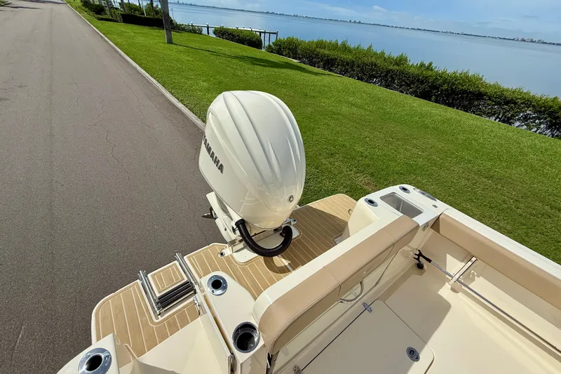  Yacht Photos Pics 2025 Scout 240 XSF boat with Yamaha engine, docked by a scenic waterfront.