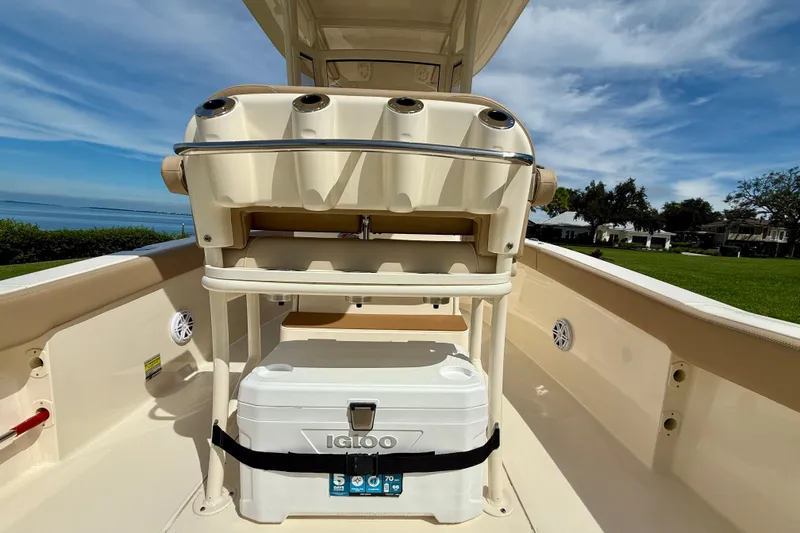 Yacht Photos Pics 2025 Scout 240 XSF boat interior with cooler and rod holders, scenic waterfront view.
