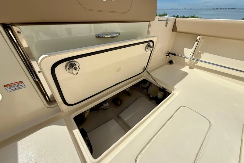  Yacht Photos Pics 2025 Scout 240 XSF boat storage compartment open, showcasing interior details.